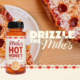Close-up pour from Mike's Hot Honey original bottle highlighting drizzle control.
