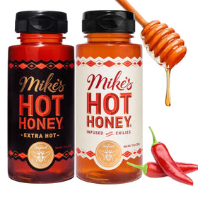 Mike's Hot Honey Original bottle pour showing sweet heat on pizza.