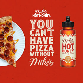 Mike's Hot Honey being drizzled, ideal on pizza and wings.