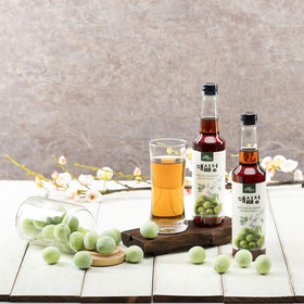 Green plums visible in syrup highlighting natural ingredients.