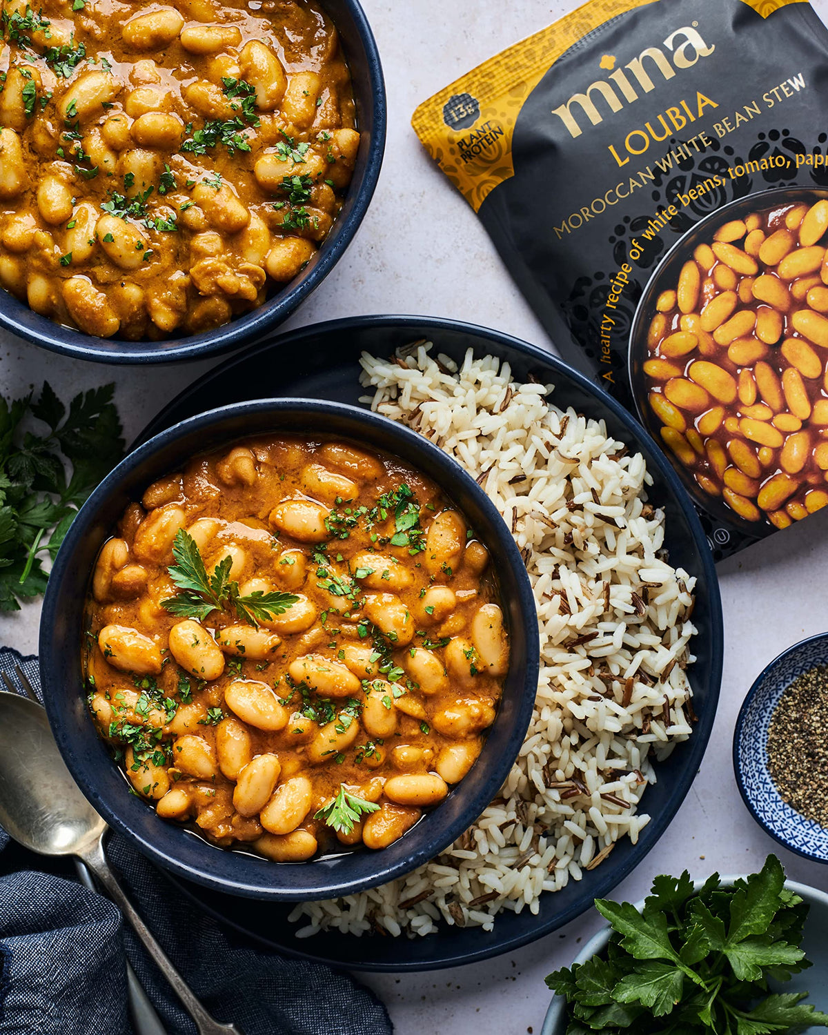 Mina Loubia stew vegan-friendly seal emphasizes plant-based comfort.