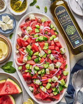 Mina Olive Oil drizzled on a vibrant salad for light flavor.