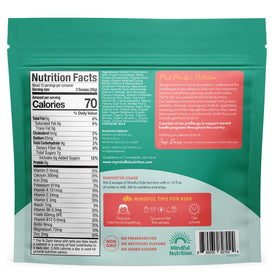 Mindful Nutrition chocolate mix in glass illustrating creamy chocolate milk ready to enjoy.