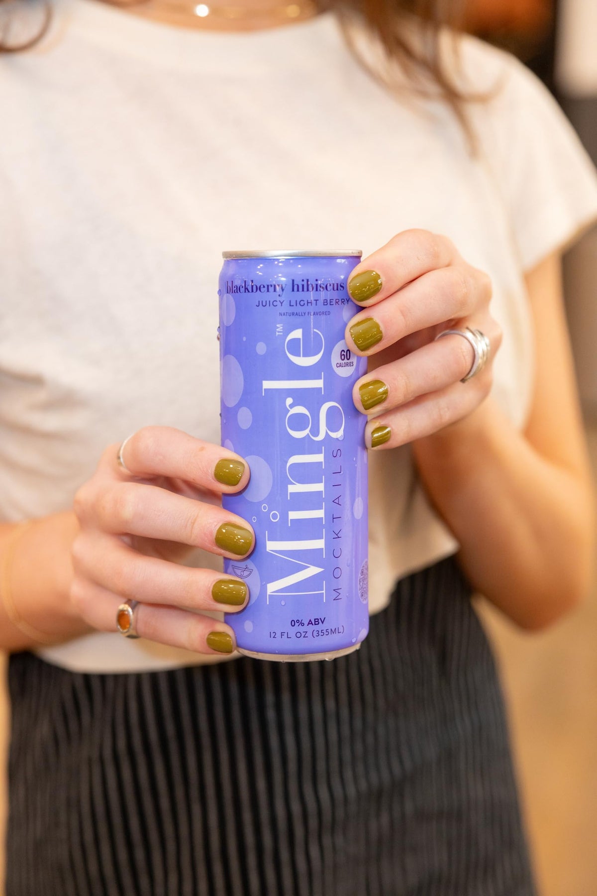 Mingle Sparkling Mocktails Blackberry Hibiscus Bellini pour into glass—zero-alcohol, versatile entertaining choice.