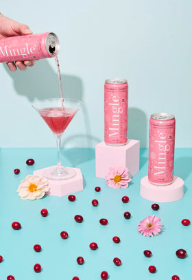 Chilled Mingle Cranberry Cosmo can on a party table, perfect for gatherings