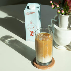 Minor Figures Organic Light Oat Milk being poured into a cup aroma.