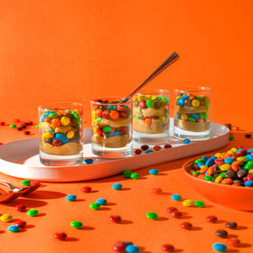 M&M'S Candies as party favors and colorful gift bag accents.