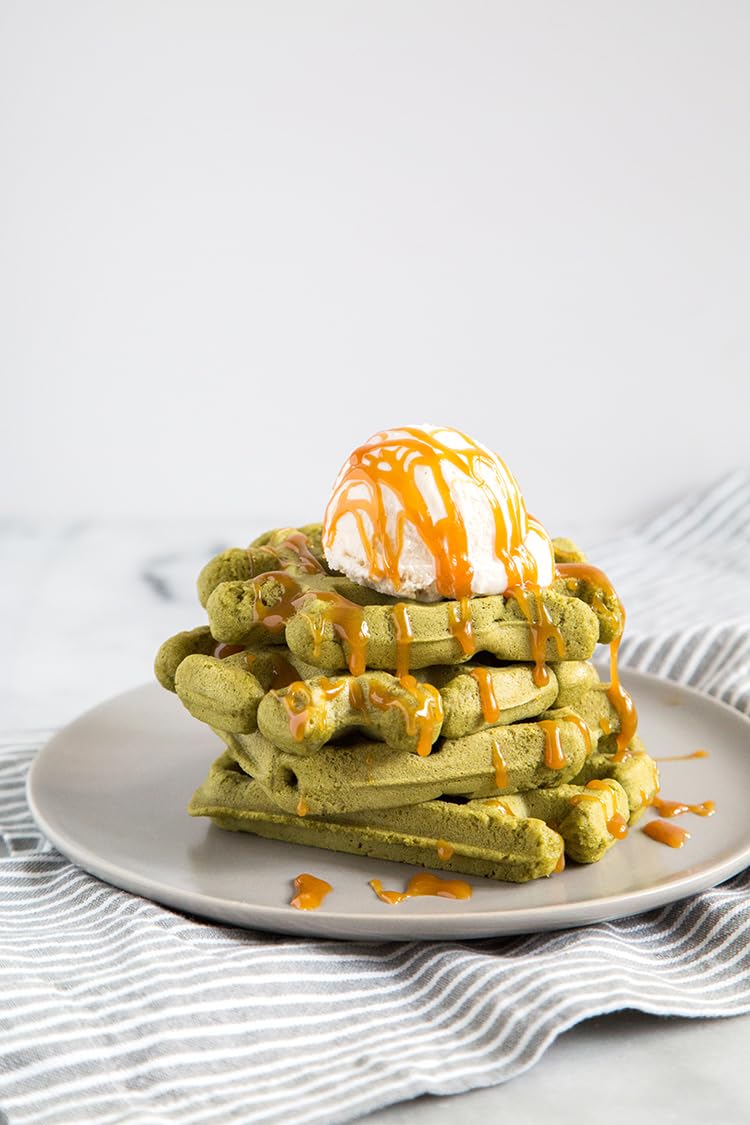 Plate of soft, chewy Mochi Foods Matcha Pancakes topped with fruit.
