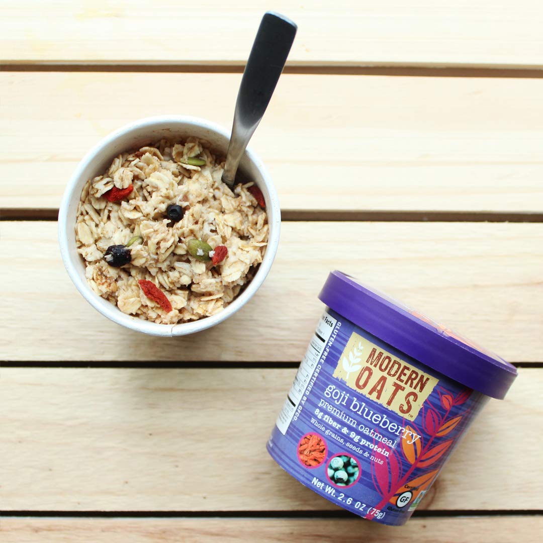 Goji berries and blueberries visible in Modern Oats Goji Blueberry cup.