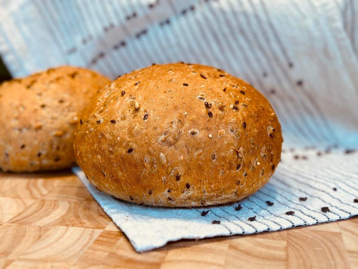 Molibake loaf baked in oven with crusty exterior and soft crumb.