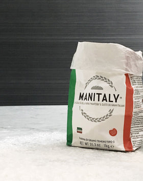 Non-GMO certification badge on Manitaly flour packaging.