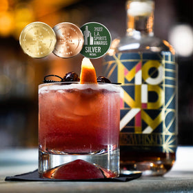 MONDAY Zero Alcohol Whiskey being poured into a glass for a mocktail