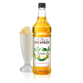 Monin Banana Syrup bottle on bar counter enhances tropical cocktails.