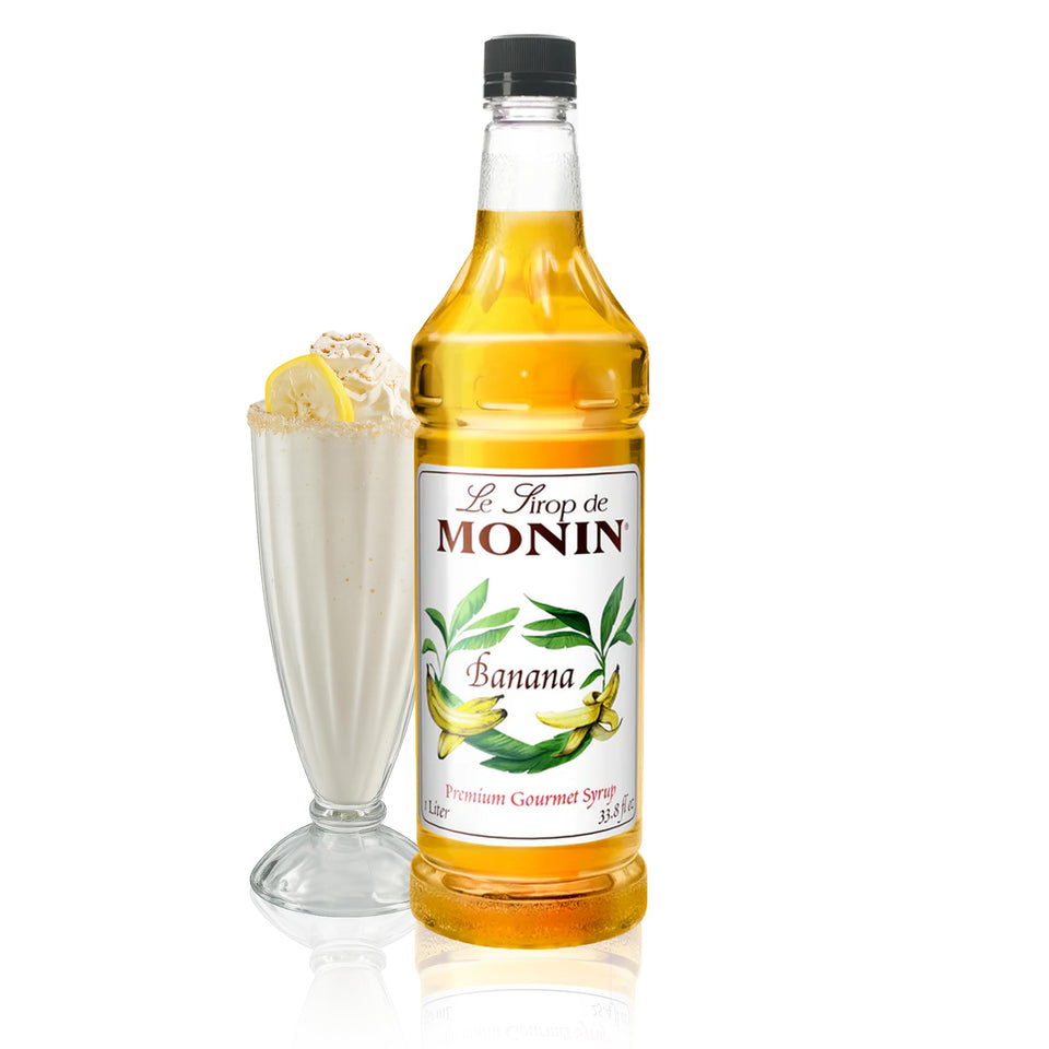 Monin Banana Syrup bottle on bar counter enhances tropical cocktails.