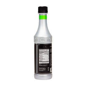 Monin Basil flavor concentrate being poured into a glass for refreshing beverages.