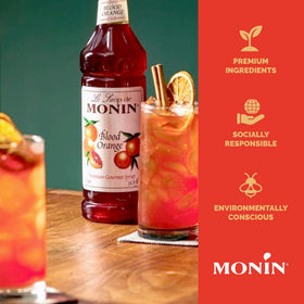 Monin Blood Orange Syrup label close-up emphasizes natural flavors and allergen-free claim.