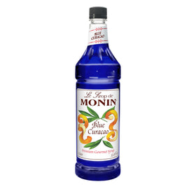 Monin Blue Curacao Syrup bottle close-up, showcasing vibrant color for cocktails and mocktails.