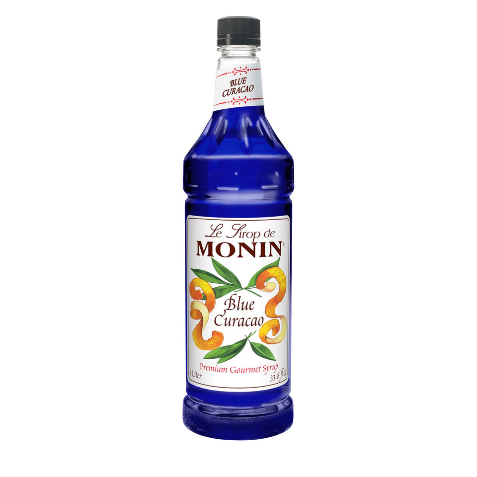 Monin Blue Curacao Syrup bottle close-up, showcasing vibrant color for cocktails and mocktails.