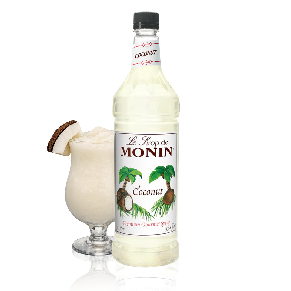 Monin Coconut Syrup bottle pouring, perfect for tropical cocktails and smoothies.
