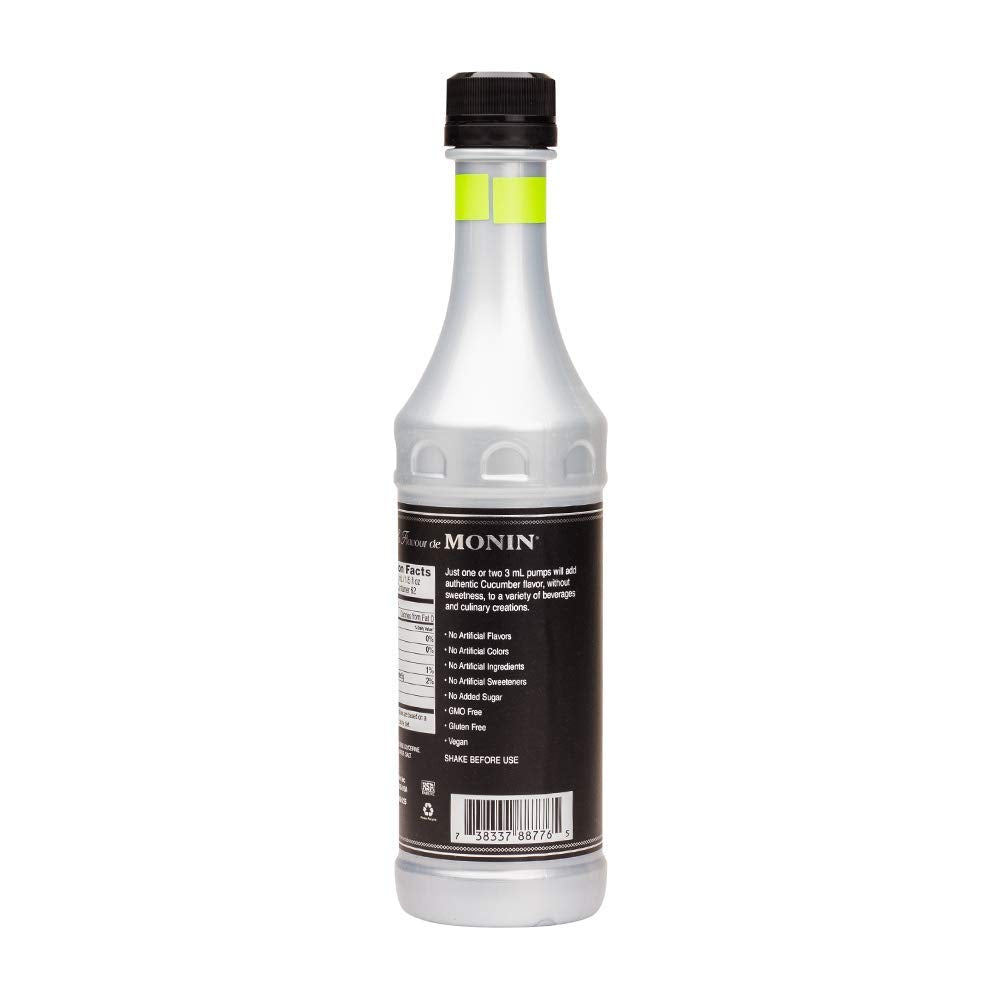 Monin cucumber flavor concentrate being poured into glass for drinks
