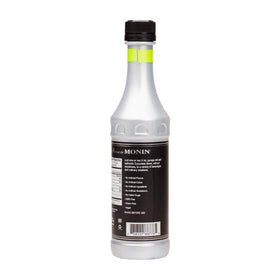 Monin cucumber flavor concentrate being poured into glass for drinks