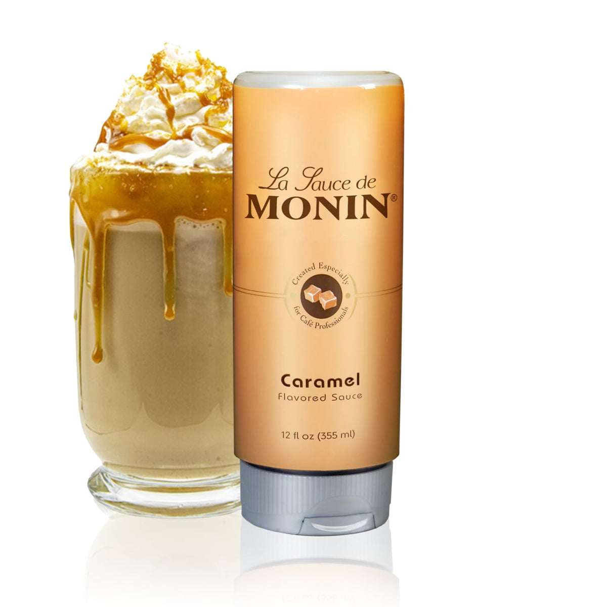 Monin Gourmet Caramel Sauce bottle pouring over coffee for a rich, buttery flavor.