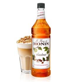 Monin Hazelnut Syrup bottle pour enhances drinks with caramelized hazelnut aroma.