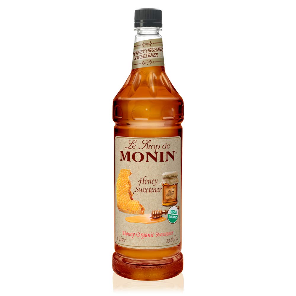 Monin Organic Honey Sweetener bottle pour showing quick-dissolve formula for hot or cold drinks