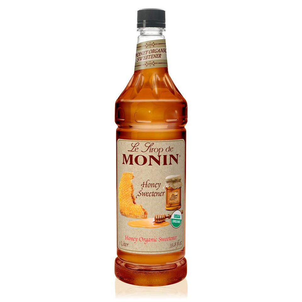 Monin Organic Honey Sweetener bottle pour showing quick-dissolve formula for hot or cold drinks