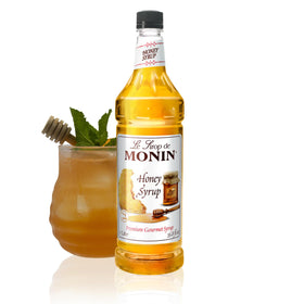Monin Honey Syrup bottle pour, highlighting smooth honey flavor for drinks