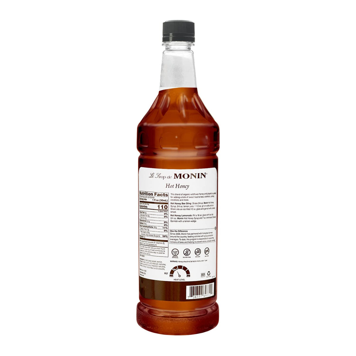 Pouring Monin Hot Honey Syrup into lemonade for a balanced sweet-spicy twist.