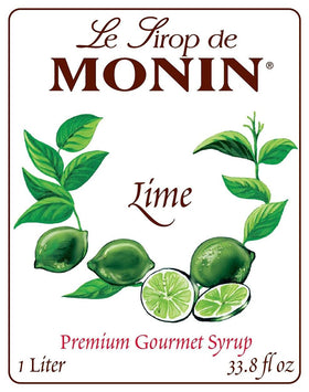 Pouring Monin Lime Syrup into a glass for zesty cocktails
