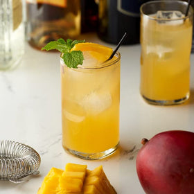 Monin Sugar Free Mango bottle pour illustrates versatile mango flavor for drinks.