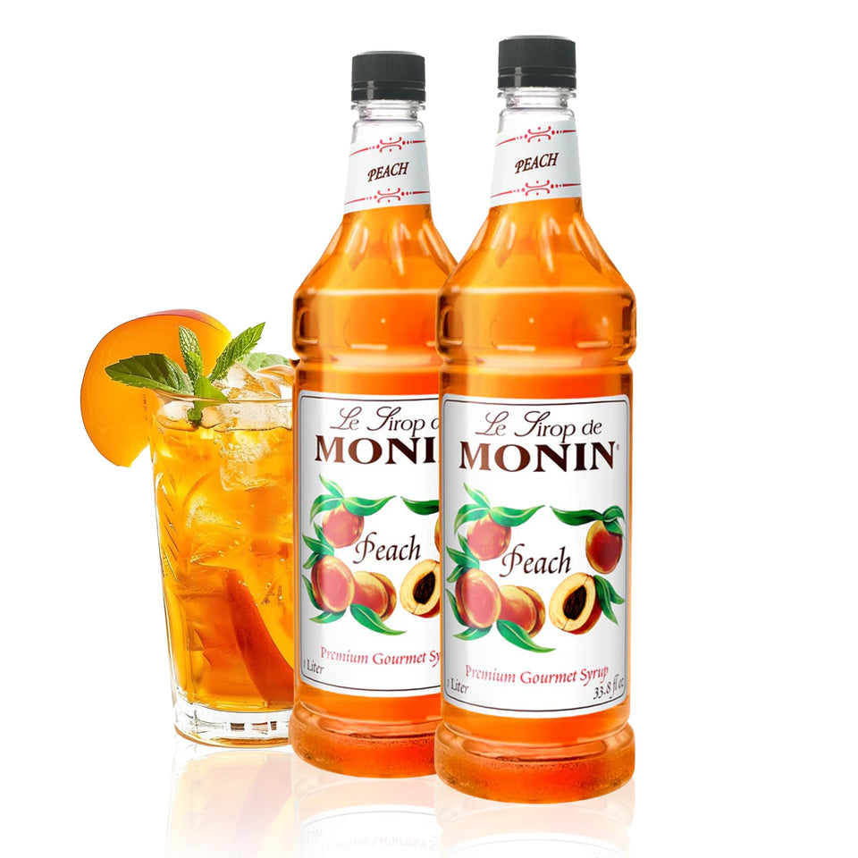 Monin Peach Syrup bottle pour for refreshing iced tea and lemonades.