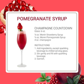 Monin Pomegranate Syrup glass with cocktail demonstrates rich crimson presentation
