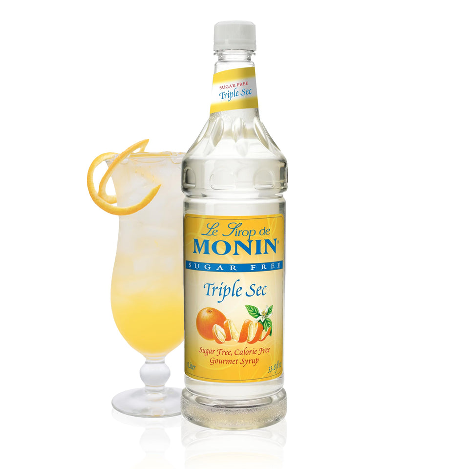 Monin Sugar Free Triple Sec syrup bottle pouring for zero-calorie cocktails.