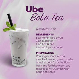 Monin Ube Blend Syrup bottle beside a refreshing lemonade for color enrichment