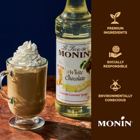 Monin White Chocolate Syrup bottle shown with eco-friendly packaging and sustainability notes.
