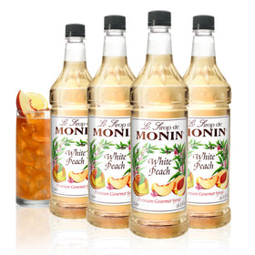 Monin White Peach Syrup bottle hero, ideal for cocktails and iced teas.
