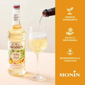 Iced tea tinted peach with Monin White Peach Syrup for a bright sip.