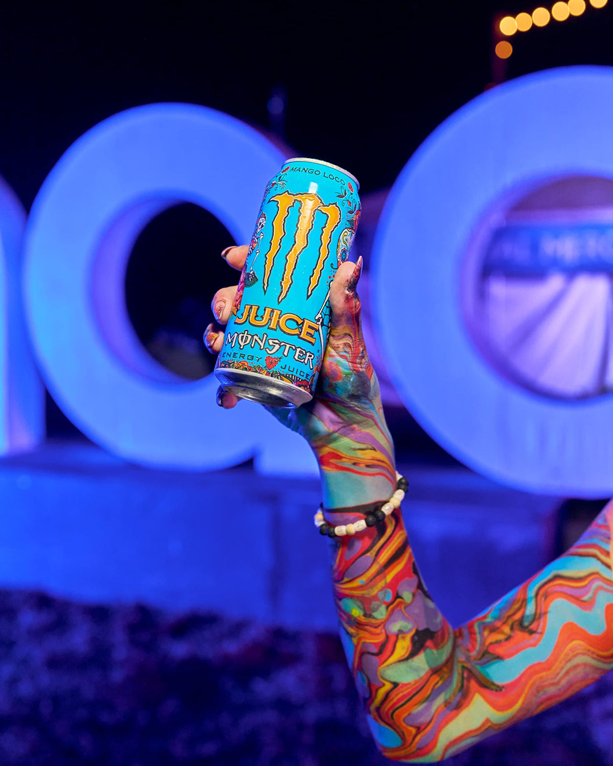 Party scene featuring Monster Mango Loco inviting friends to share energizing moments.