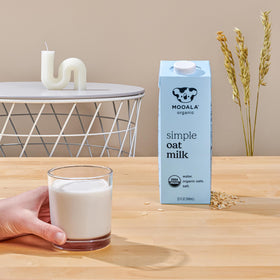 Mooala milk being poured into glass, showing creamy texture