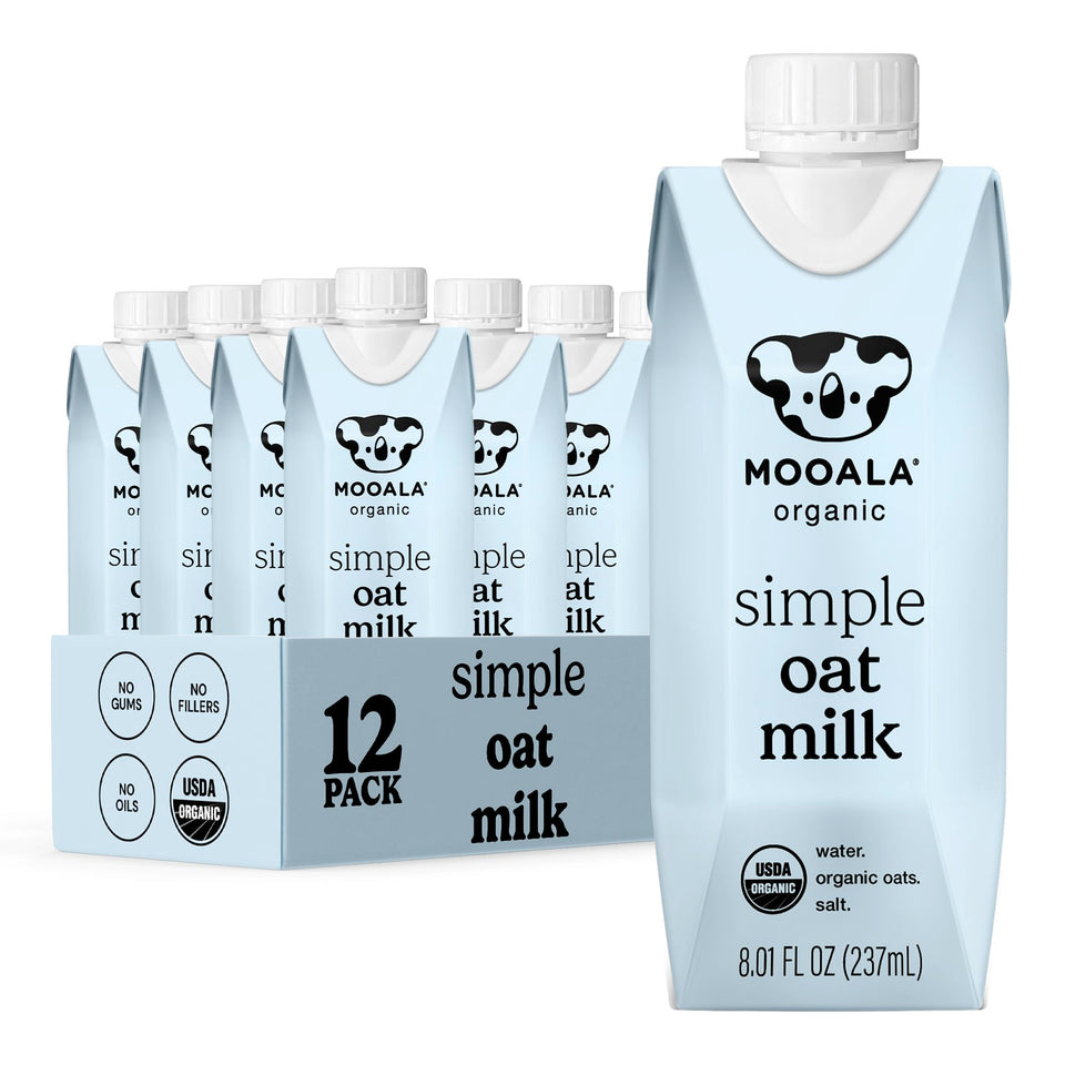 Mooala Organic Simple Oatmilk carton pouring into coffee for a creamy, dairy-free sip