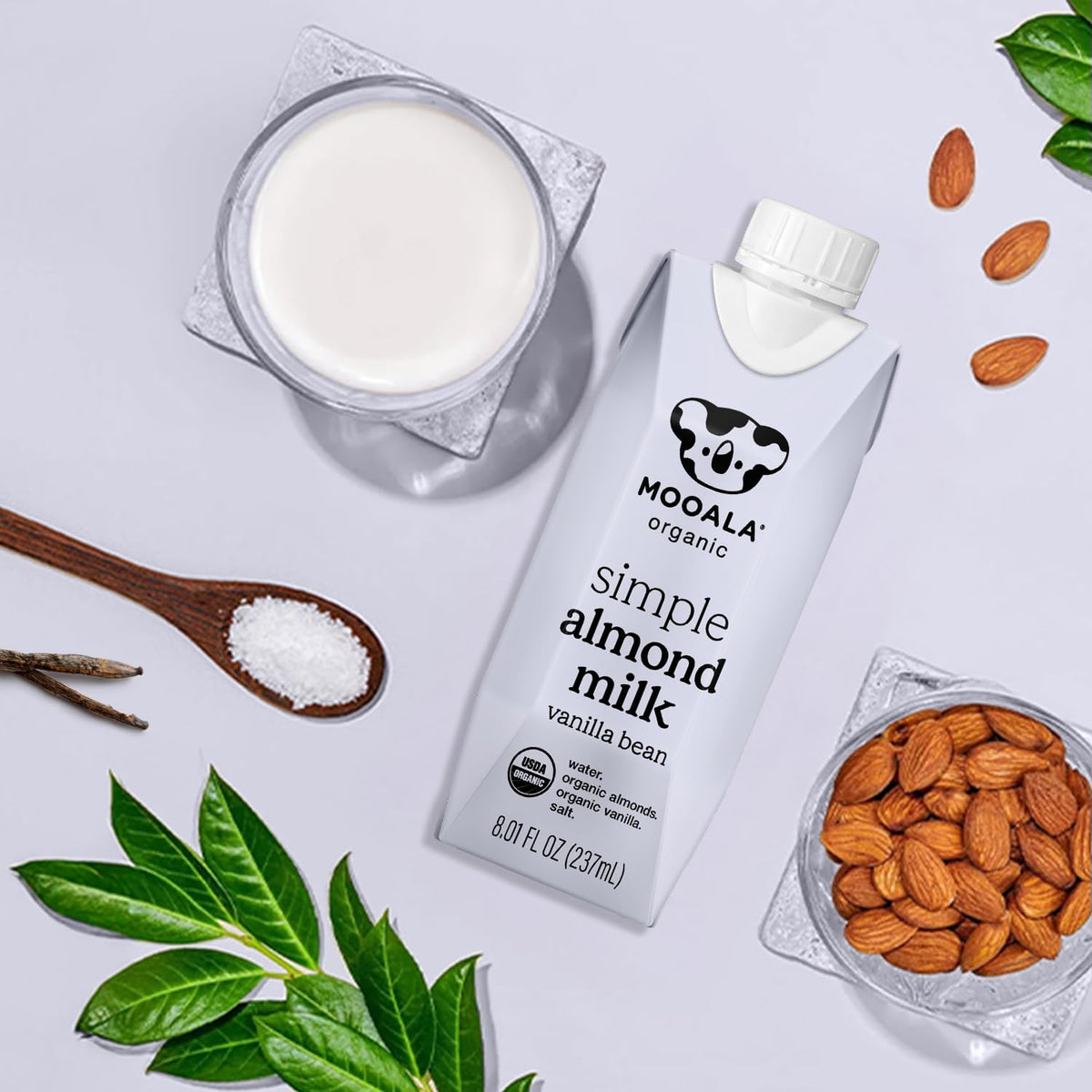 Mooala Vanilla Almond Milk being poured into a glass for a dairy-free latte or smoothie.