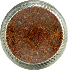 Multi-use seasoning being sprinkled into a pan for quick flavor.