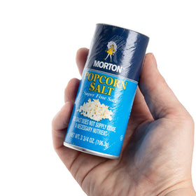 Morton popcorn salt shakers in use during family movie night.