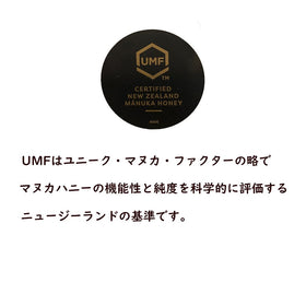 Pouring Mother Earth Manuka honey UMF10 with a smooth drizzle.