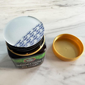 Spoonful of Mother Earth Manuka honey UMF10 ready to sweeten tea.
