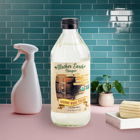 Pouring Mother Earth Vinegar from bottle into pan.
