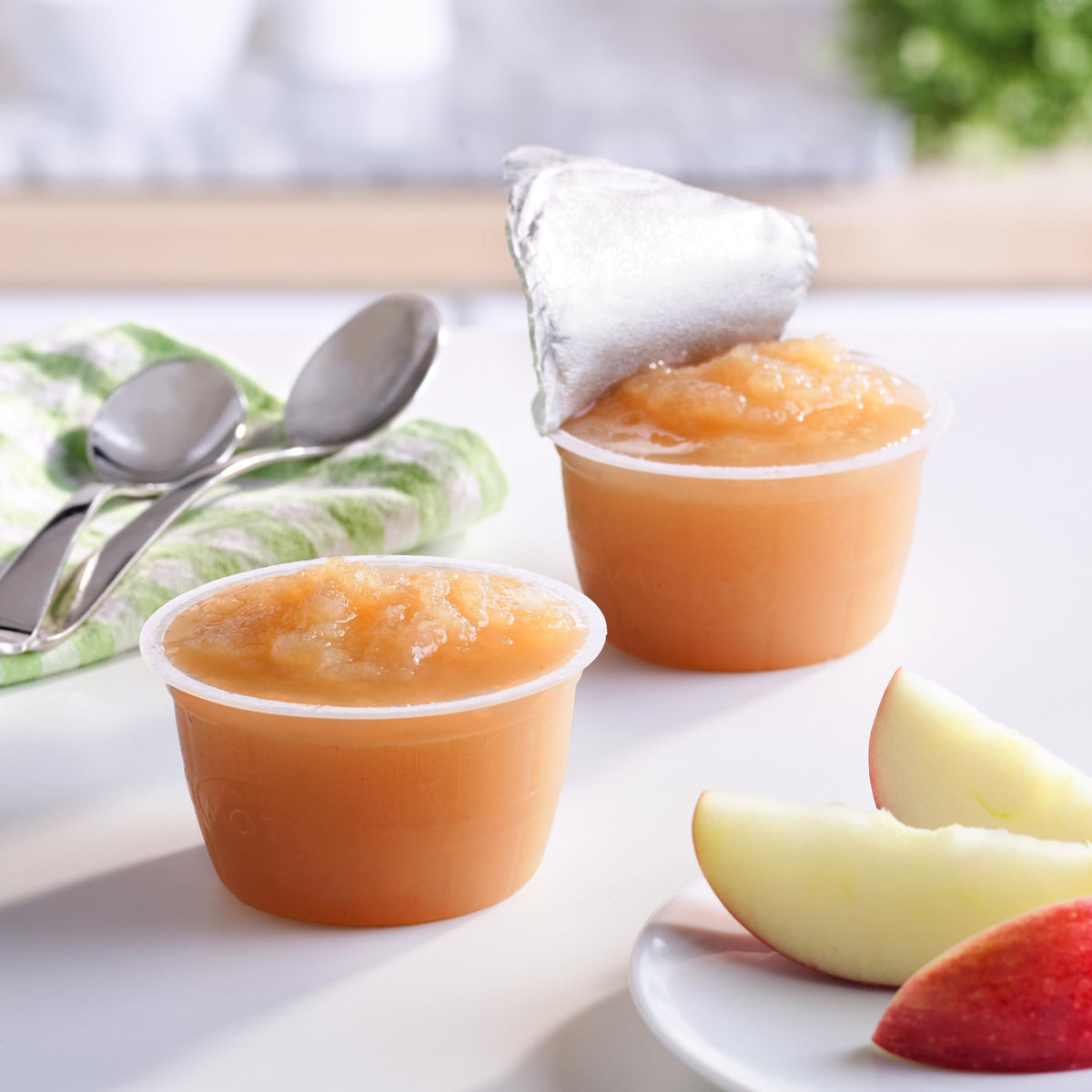 Mott's Mango Peach Applesauce close-up with peach and mango swirl in a 4 oz cup